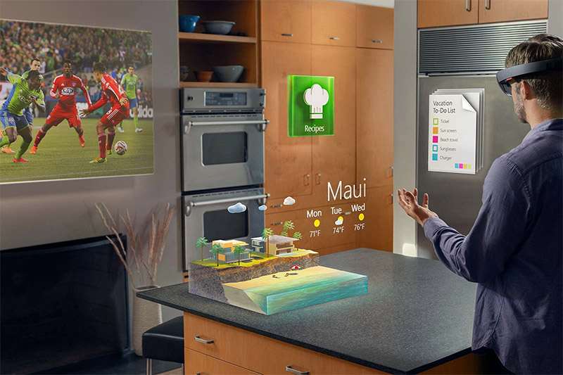 A man is wearing HoloLens in his kitchen.