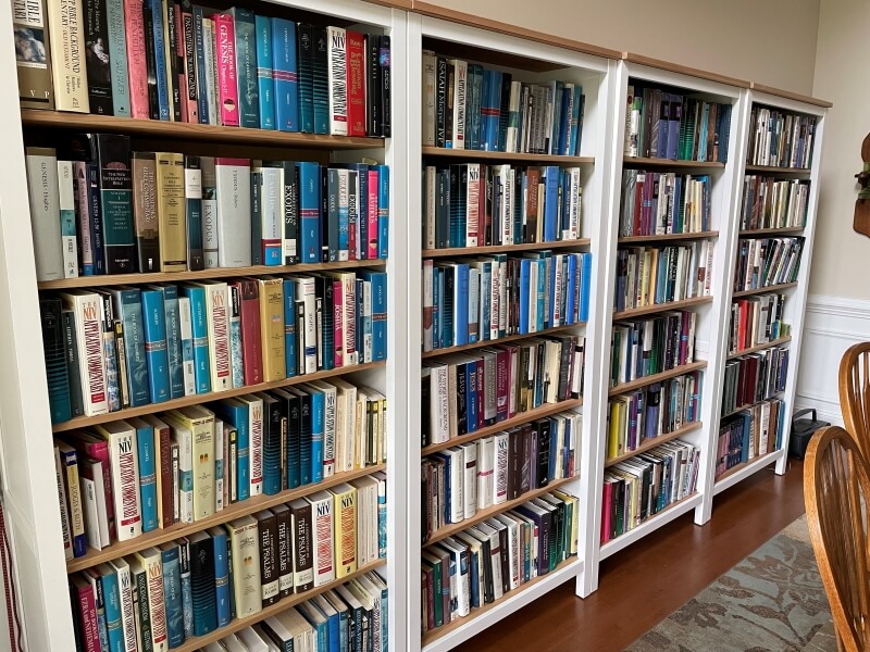 Four bookcases full of Bible reference works.