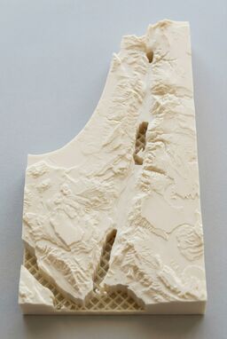  A lightweight, ultra-precise 3D-printed map — thin shells build mountain ridges and river valleys — hollow inside but perfectly capturing the external shape — clean layers, smooth finishes, designed for the modern hand.