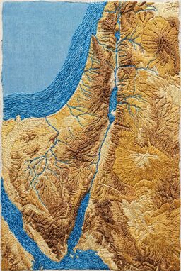  A visual map that looks like it’s stitched with thread — brown stitches for mountains, blue embroidery for rivers, golden thread for desert sands — tactile and handcrafted but precise.