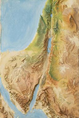  A map where gesso (thick priming paste) is built up into low mountains, flowing valleys, soft plains — then overpainted with thin color washes that catch only the texture — land emerging through relief and subtle color.