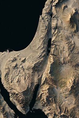  A map where mountains and valleys are sharply etched with high-contrast shading — ridges pop forward, valleys plunge back — giving the land a sculpted, almost carved-stone feel.