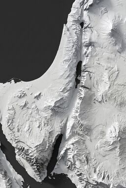  A terrain map with no color or lines — only shadows and highlights revealing the landforms. Almost like sunlight raking across a 3D model of the terrain. Minimal yet deeply dimensional. Bodies of water should be visible.