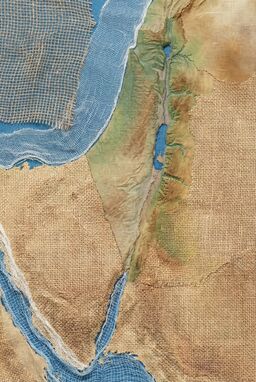  A map built from overlapping textures — rougher weave textures for deserts, tighter smoother textures for valleys, looser open meshes for coastlines — geography revealed by surface feel rather than drawn forms.