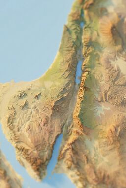  A simulated tilt-shift photo of ancient Israel's terrain—realistic shading but with exaggerated blur at the top and bottom edges, making the map feel like a tiny living model world.
