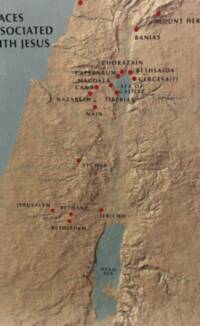 The map uses an aerial-style shaded relief basemap with muted tan land, blue-green water, black all-capital serif labels, and red filled point markers for places.