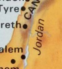 Close crop of a landcover-colored Palestine map segment with dark city dots, coastal water, and the Jordan River label.