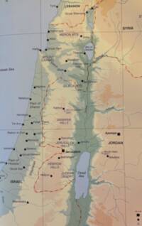 The map uses pale blue-gray water, black sans-serif labeling, red dashed political boundaries, and distinct hypsometric elevation tints in green-gray, tan, beige, and brown.