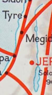 Cropped view of a full-color National Geographic-style map with cream land, pale blue hydrography, manual shaded relief, thick red route lines, and mixed black serif and red sans-serif settlement labeling.