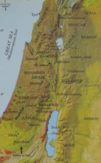 The map combines painted landcover tints, manual shaded relief, pale blue water, and dark brown serif labeling, with city point symbols and a single prominent arrow annotation near the Valley of Salt.