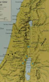 Map uses muted olive land, blue-gray water, manual shaded relief, green-gray hydrography, and dark brown-black labeling.
