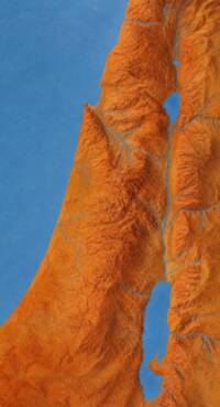 The visible map is an unlabeled shaded-terrain rendering with blue water and drainage over orange-brown land.