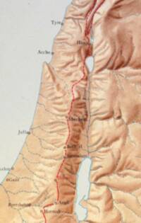 Oblique-looking manual shaded relief dominates the map, with tan land, reddish-brown terrain modeling, blue-green water and drainage, and a red directional route overlay through the central hill country.